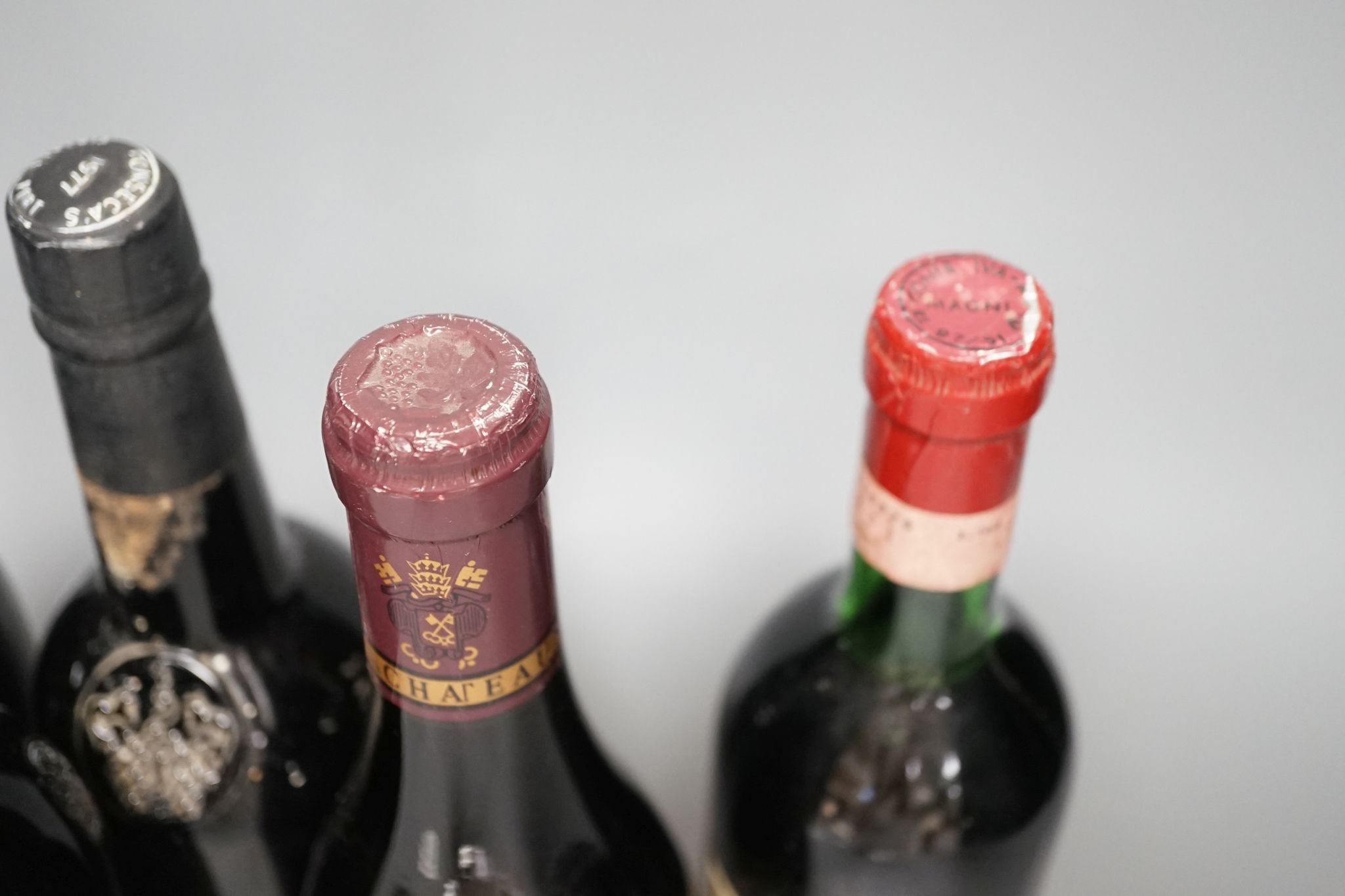 A bottle of Warres 1963 Vintage Port, a bottle of Fonsecca, 1977 Vintage Port and three bottles of wine
